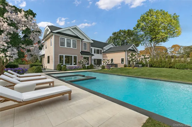 a view of house with swimming pool and yard