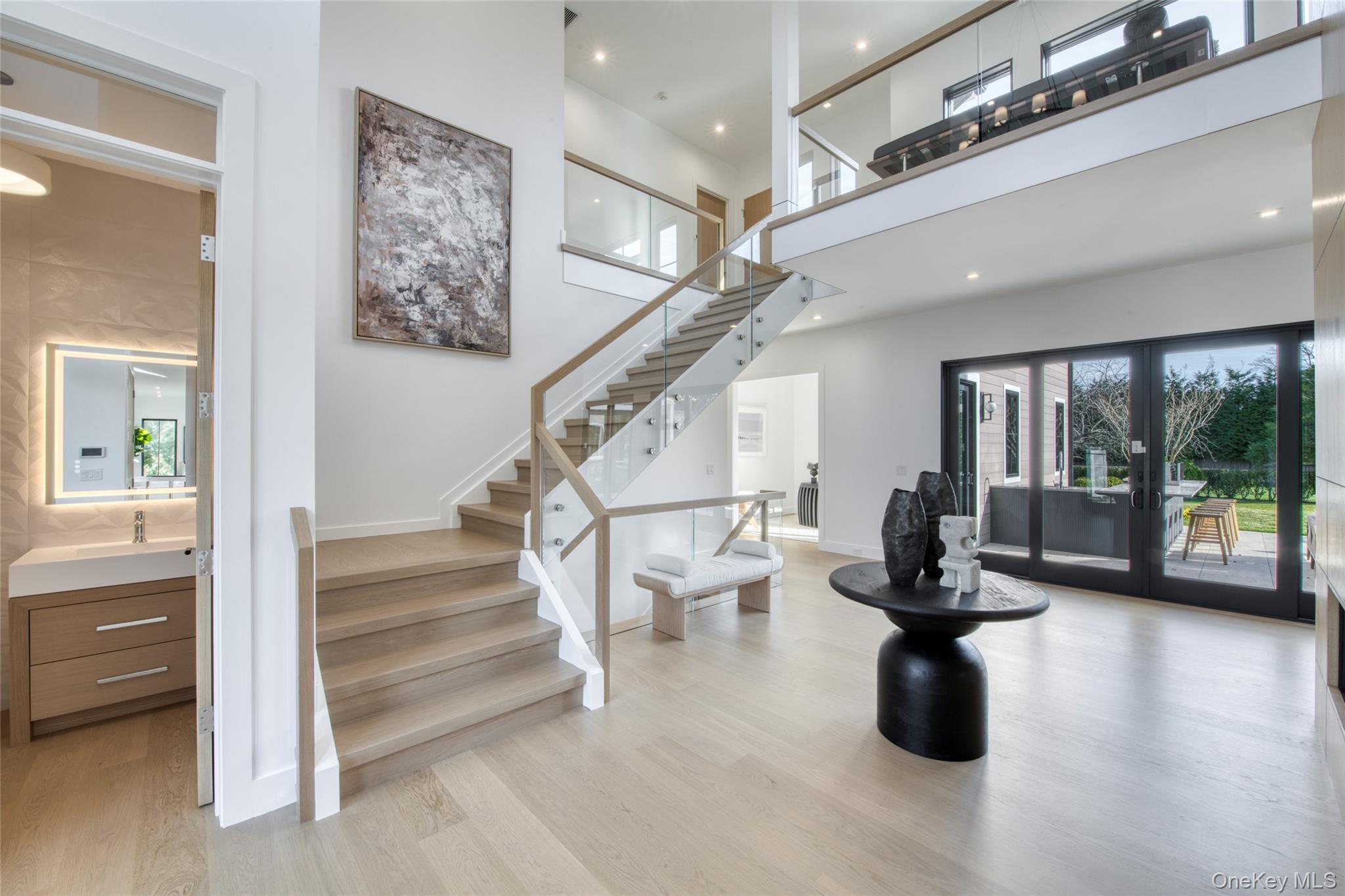 158 Cobb Road Water Mill, NY 11976 - Photo 5 of 43 Stairs with french doors, wood finished floors, and a high ceiling