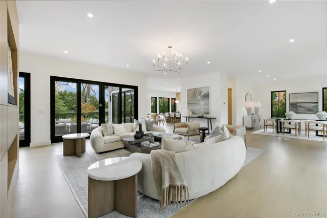 a living room with furniture and large windows