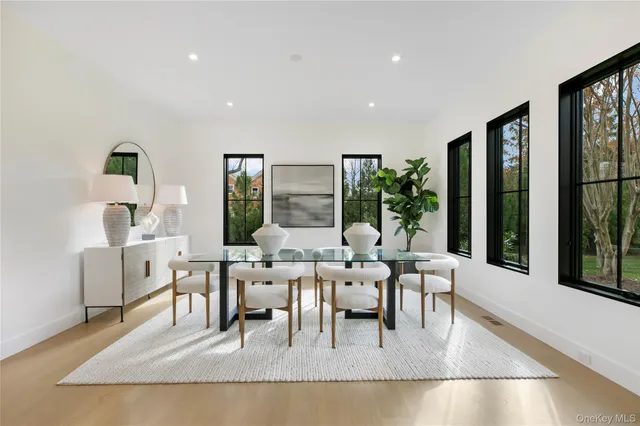 a living room with fireplace furniture and a large window