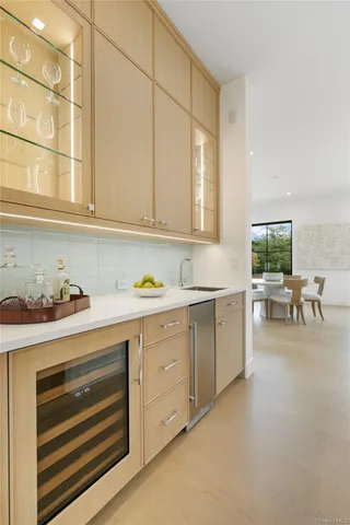 a kitchen with sink cabinets and dining table chair