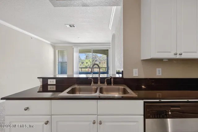 a kitchen with a refrigerator and cabinets