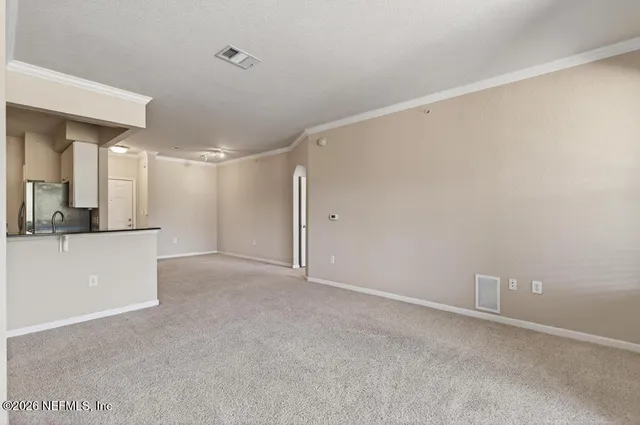 an empty room with a window and a ceiling fan