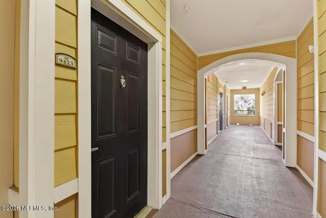 a view of a brick house with a small yard