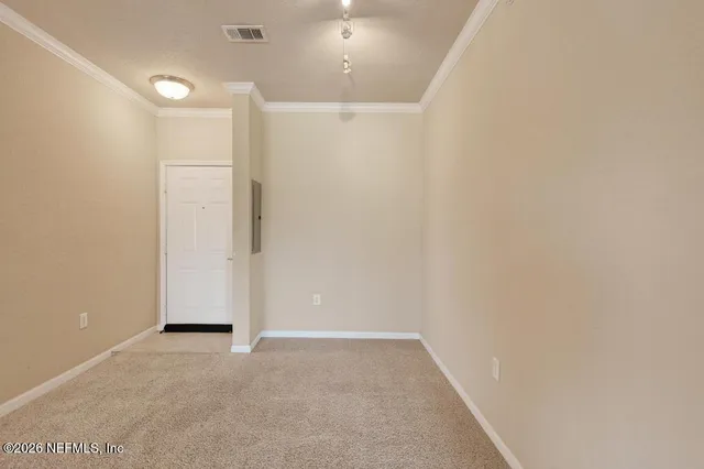 a view of a hallway to room and kitchen