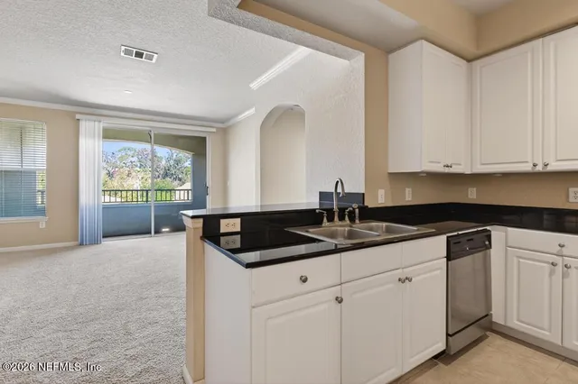 a kitchen with stainless steel appliances granite countertop a refrigerator and a stove