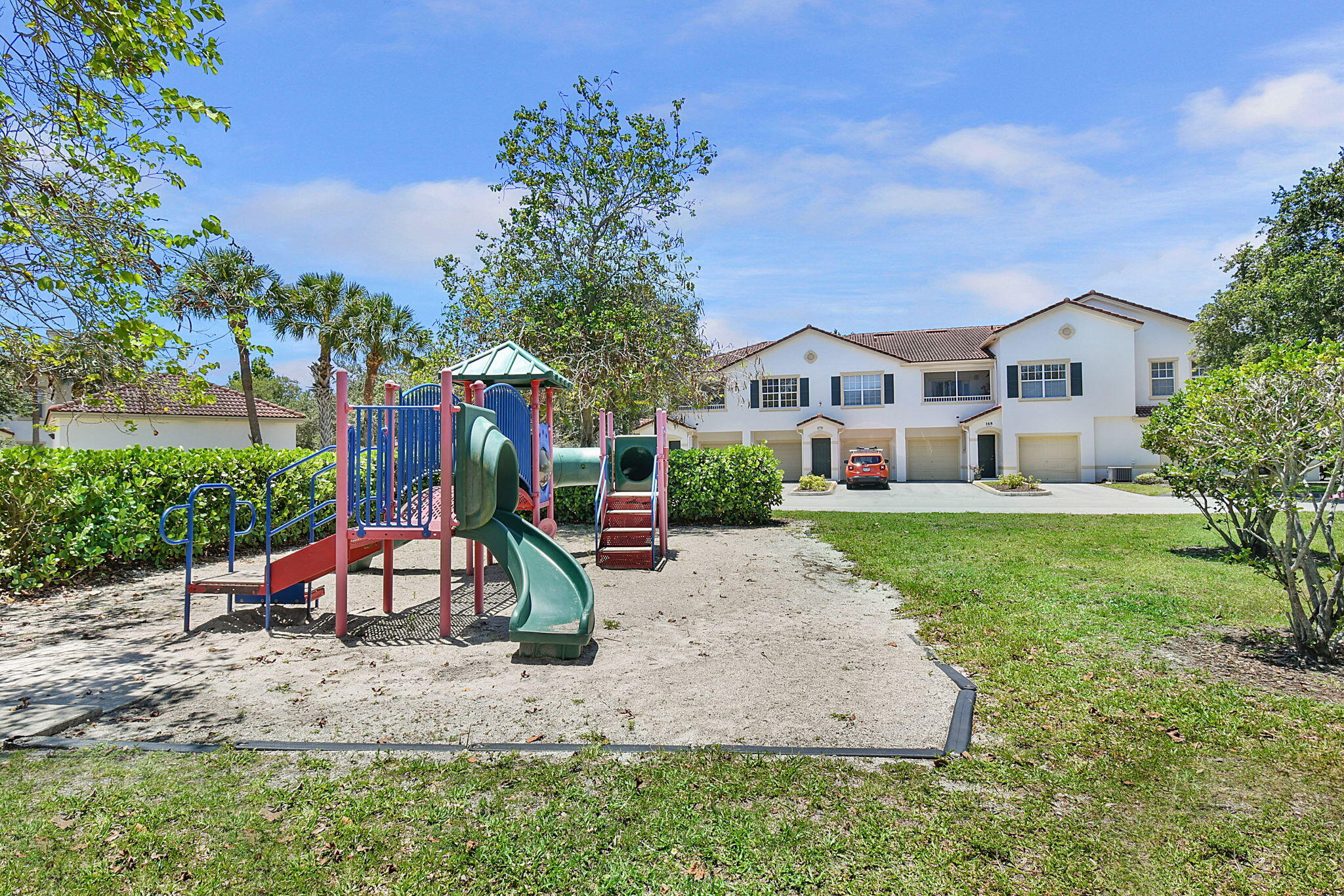 174 Southeast Kitching Circle, Unit 174 Stuart, FL 34994 - Photo 33 of 40 a view of a house with a yard and sitting area