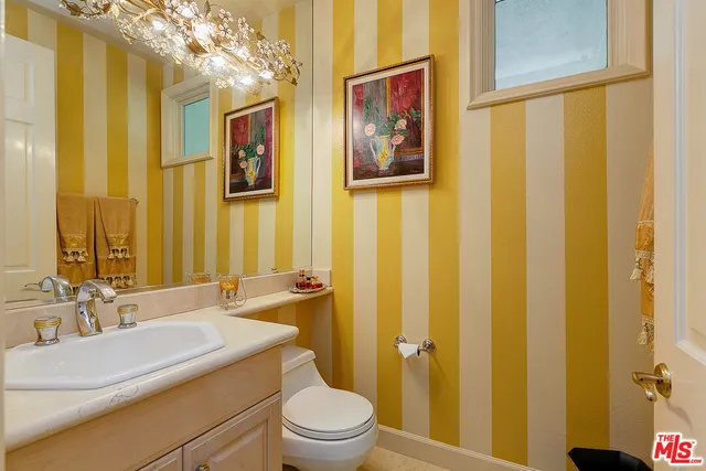 a bathroom with a sink a toilet and shower curtain