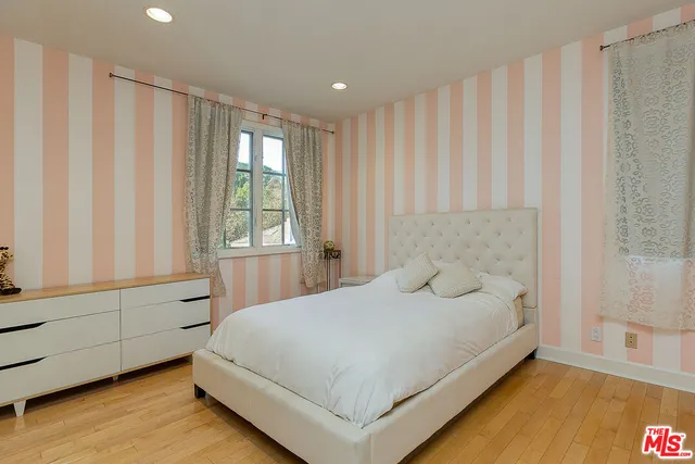 a bedroom with a large bed and a window