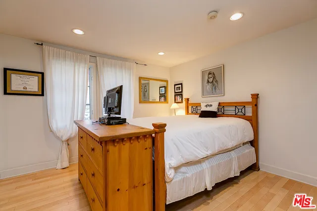 a bed room with a bed and a tv