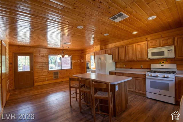 1129 Ponderosa Road, Unit 40 Hatch, UT 84735 - Photo 12 of 47 Wood-finish flooring, wood plank walls, wood plank ceiling with recessed lighting, kitchen island with built-in storage, and full range with microwave
