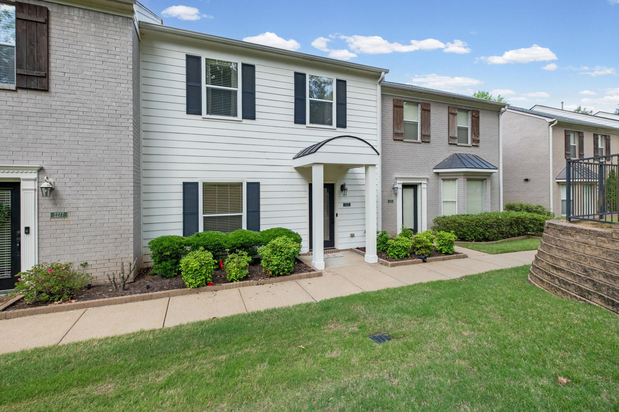 2275 McVay Road, Unit 2275 Germantown, TN 38138 - Photo 32 of 40 a front view of a house with a yard and potted plants
