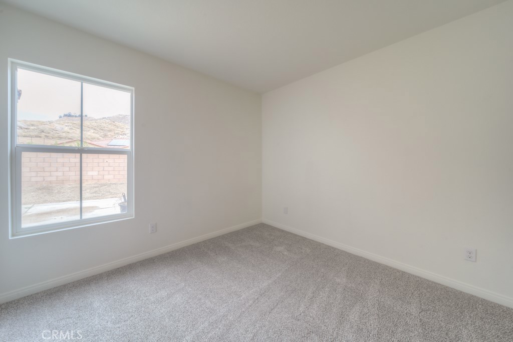 9596 Trailhead Lane Moreno Valley, CA 92557 - Photo 14 of 67 an empty room with a window