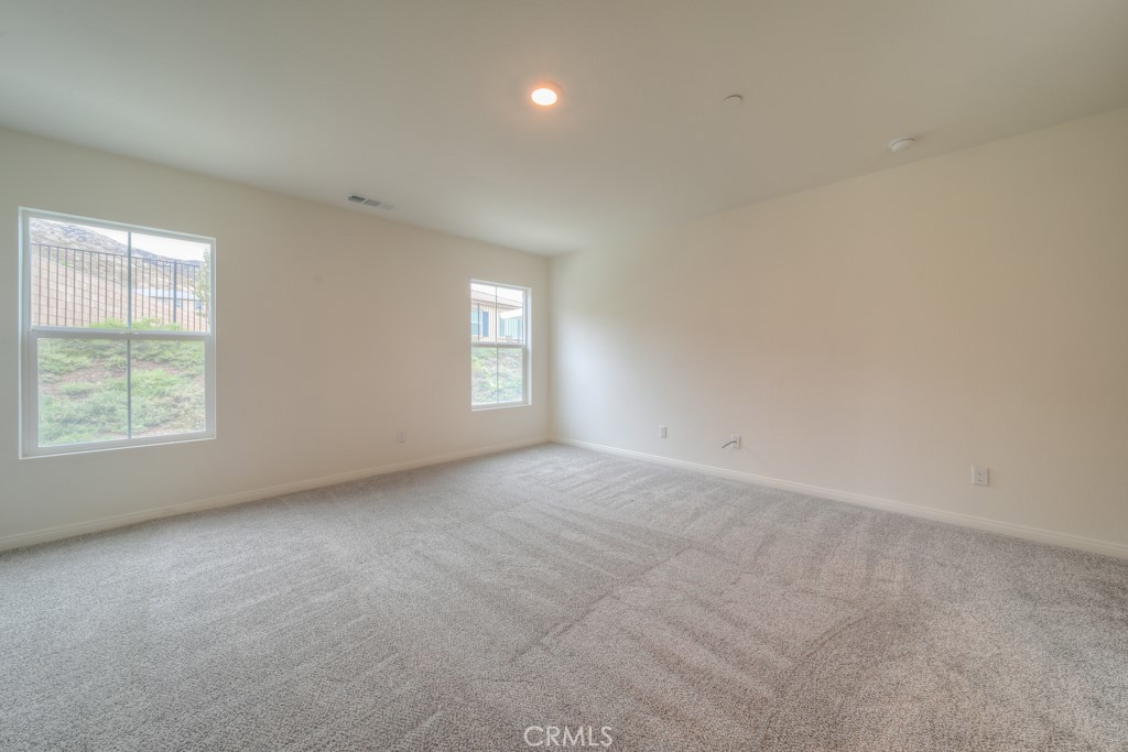 9596 Trailhead Lane Moreno Valley, CA 92557 - Photo 37 of 67 a view of an empty room with a window and closet area