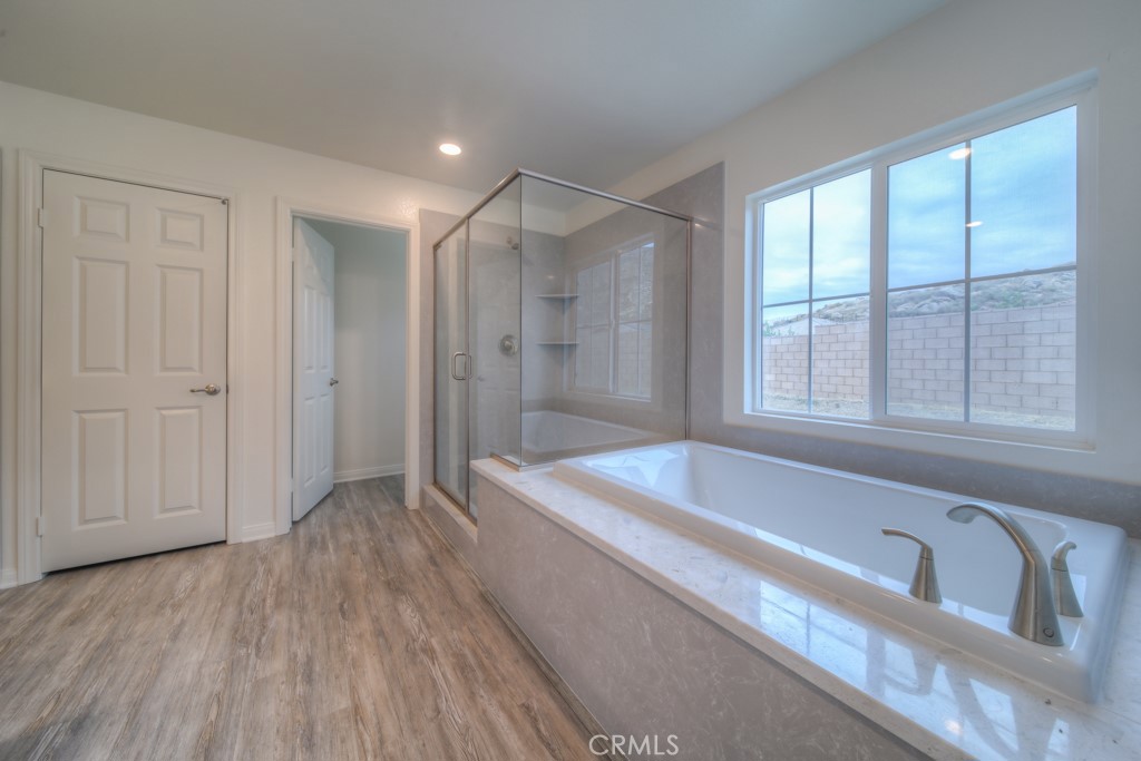 9596 Trailhead Lane Moreno Valley, CA 92557 - Photo 39 of 67 a spacious bathroom with a tub a sink and a shower
