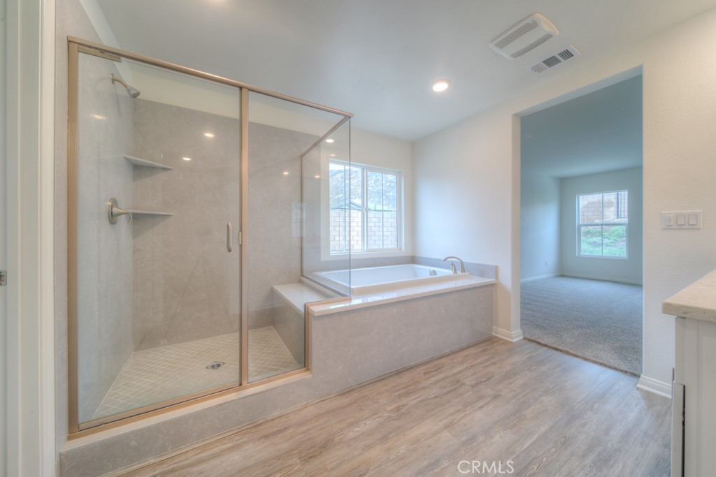 9596 Trailhead Lane Moreno Valley, CA 92557 - Photo 43 of 67 a bathroom with a bathtub and shower