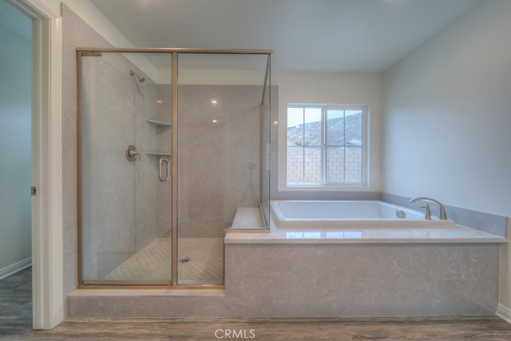 9596 Trailhead Lane Moreno Valley, CA 92557 - Photo 45 of 67 a bathroom with a bathtub and a shower