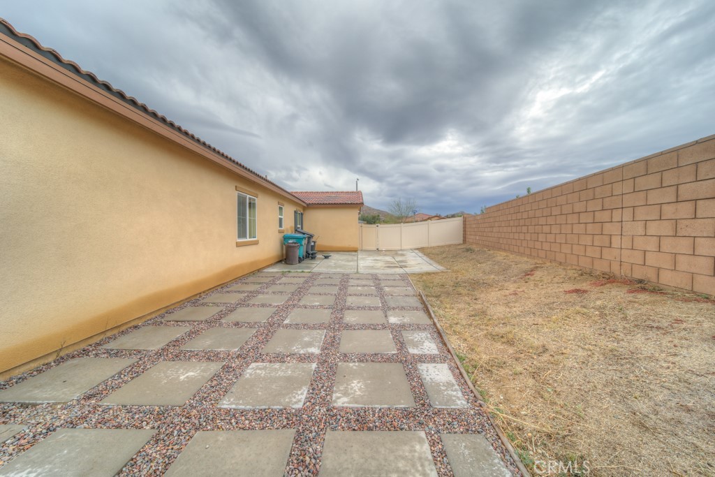 9596 Trailhead Lane Moreno Valley, CA 92557 - Photo 52 of 67 a view of a yard with wooden fence
