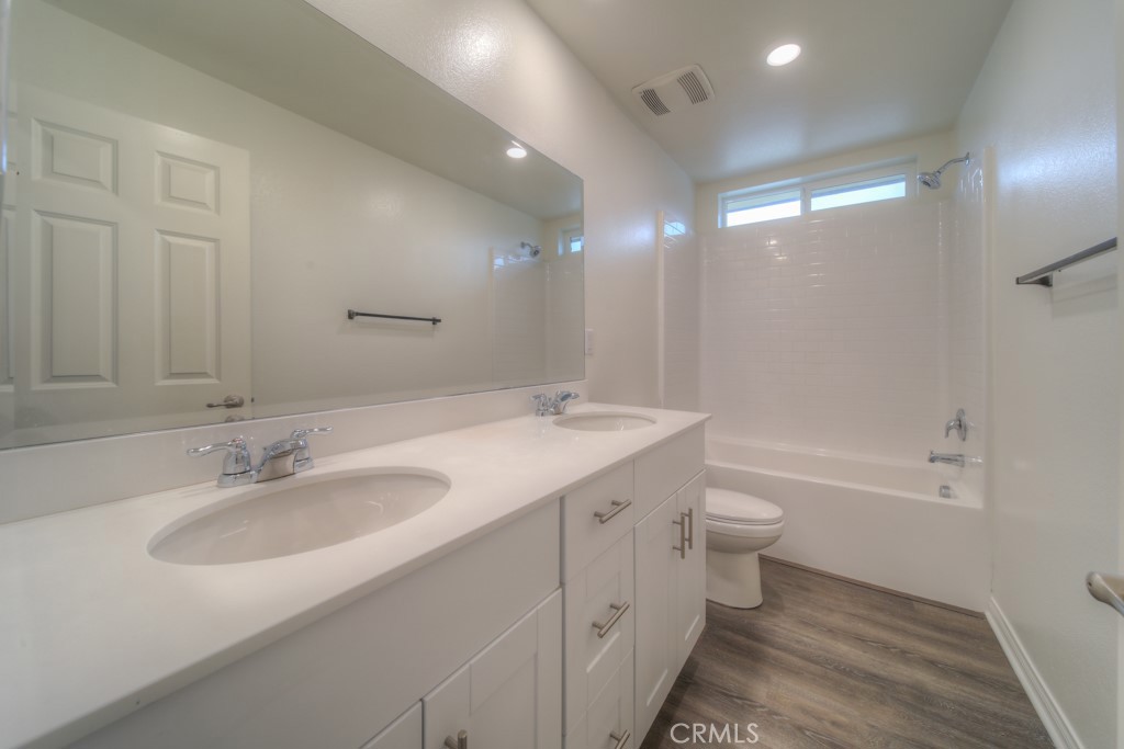 9596 Trailhead Lane Moreno Valley, CA 92557 - Photo 7 of 67 a bathroom with a sink double vanity granite toilet tub and shower