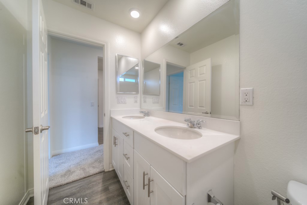 9596 Trailhead Lane Moreno Valley, CA 92557 - Photo 8 of 67 a bathroom with a sink and a mirror