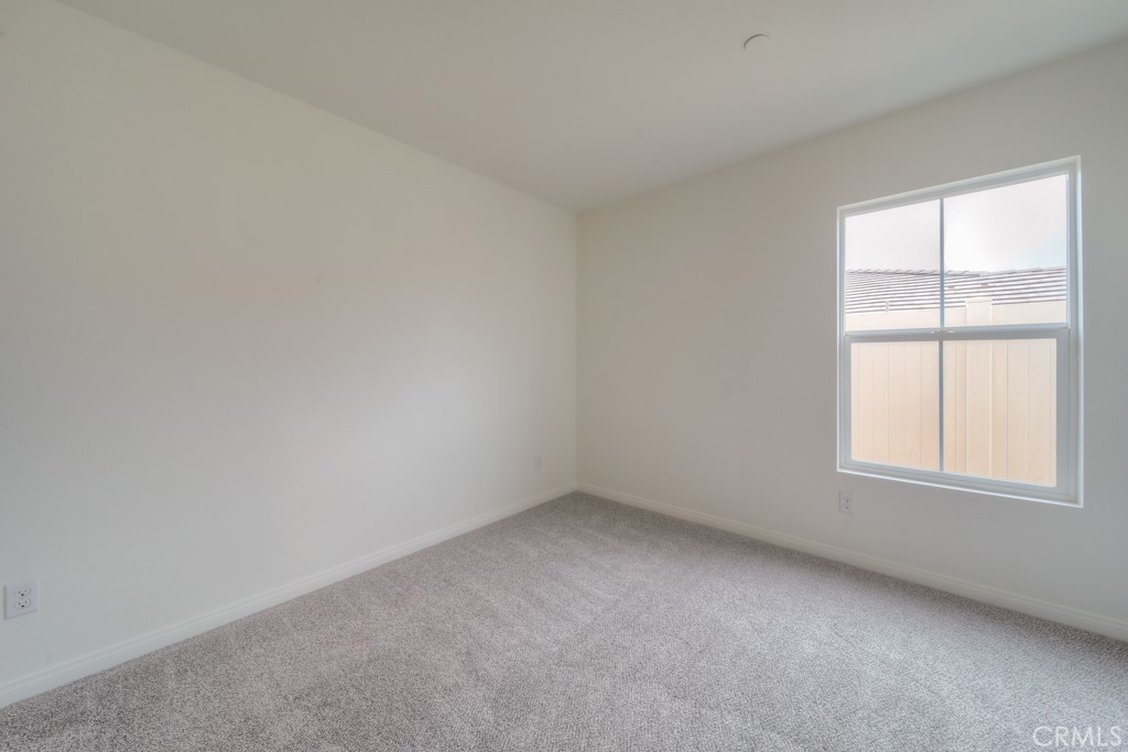 9596 Trailhead Lane Moreno Valley, CA 92557 - Photo 9 of 67 an empty room with a window