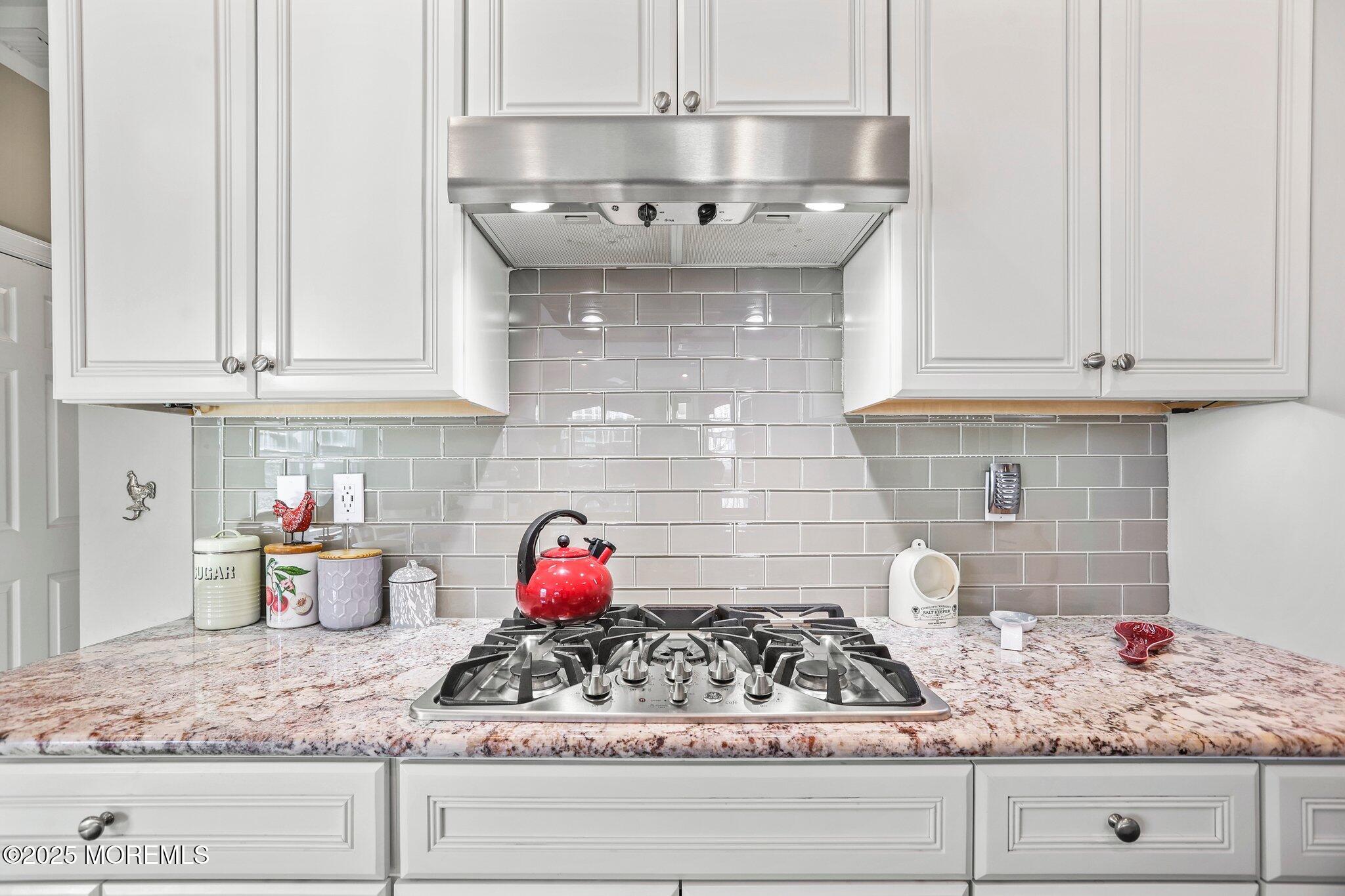 57 Harvest Ridge Road Howell, NJ 07731 - Photo 11 of 39 a kitchen with granite countertop white cabinets and a wooden floor