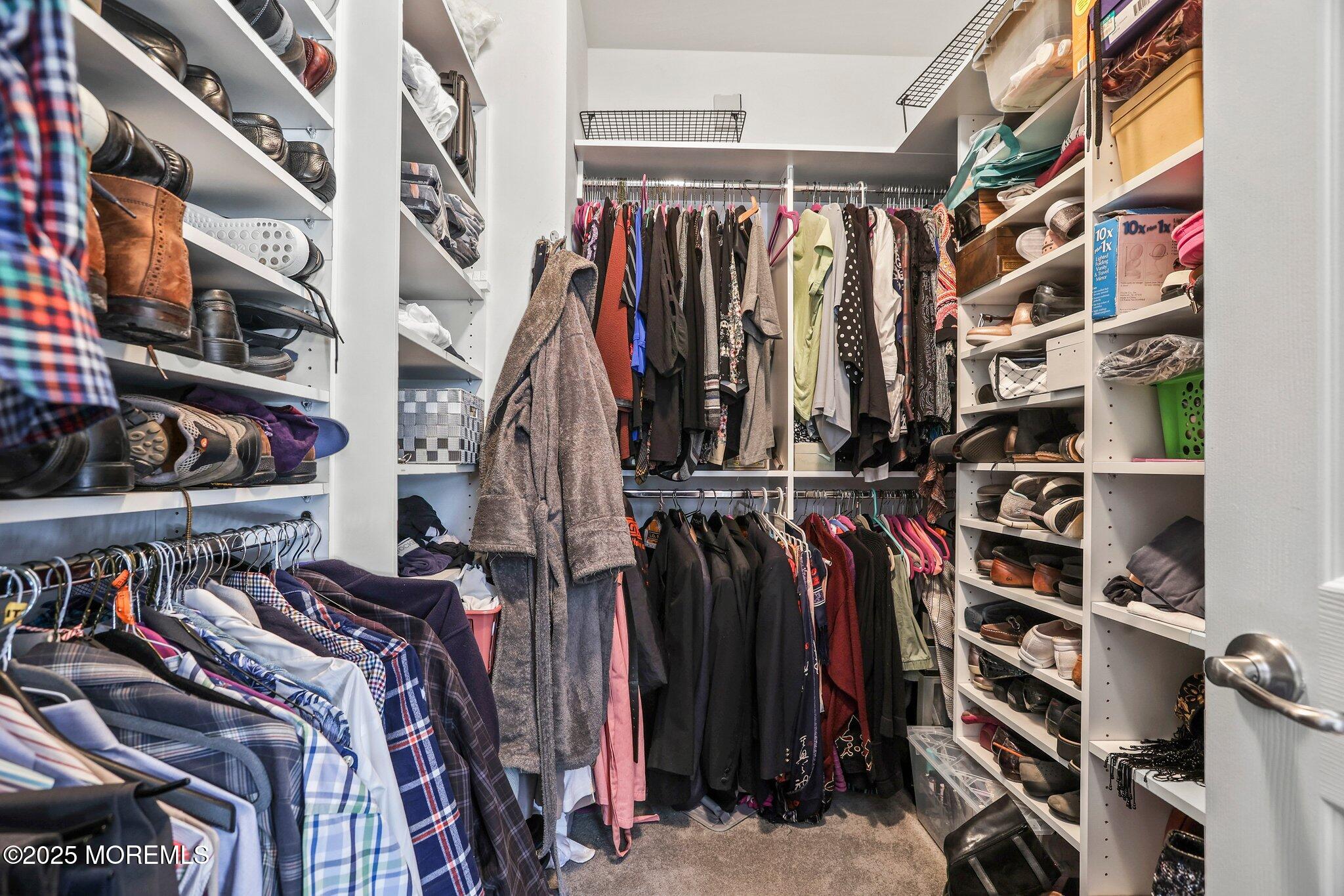 57 Harvest Ridge Road Howell, NJ 07731 - Photo 21 of 39 a view of walk in closet with clothes and shoes