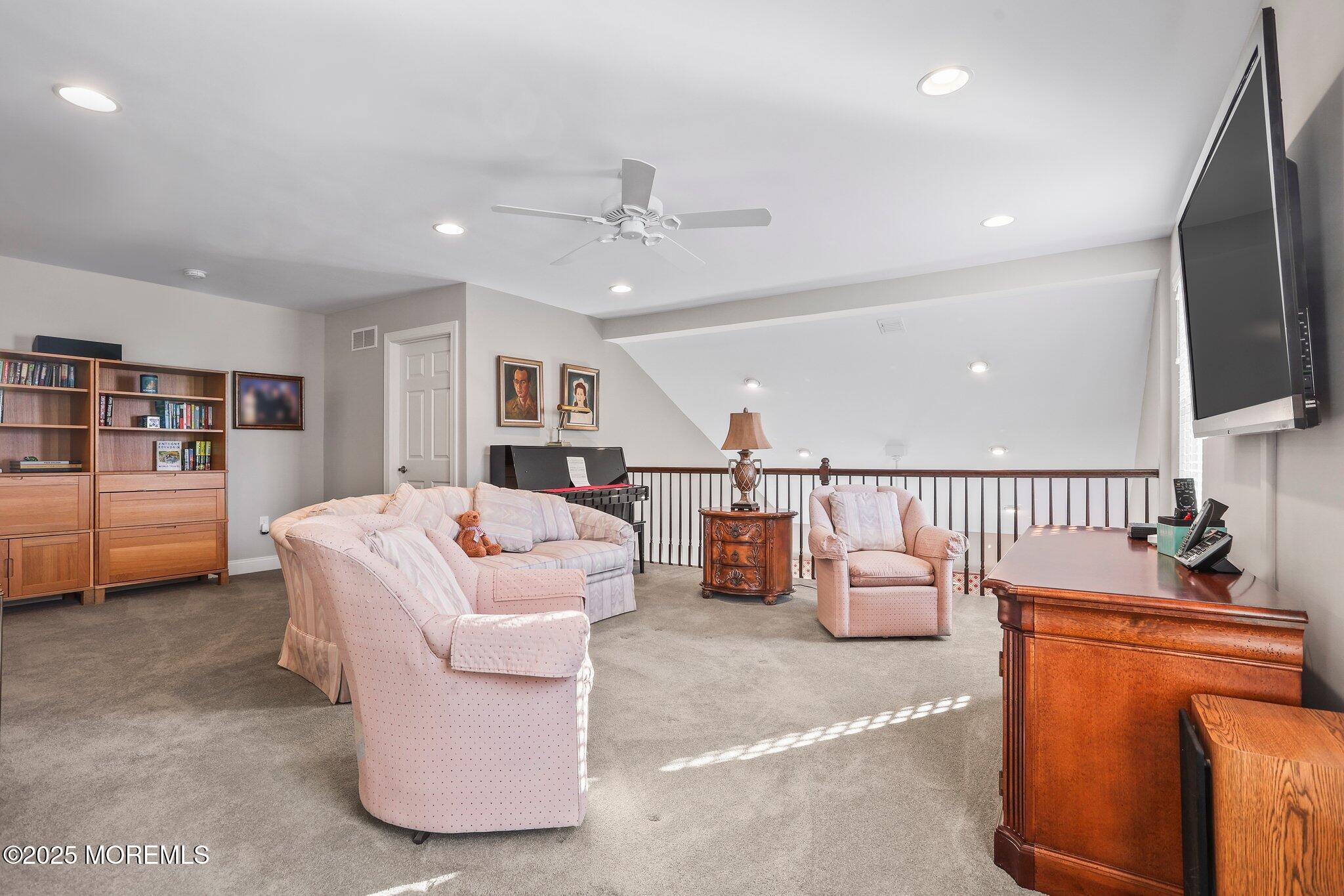 57 Harvest Ridge Road Howell, NJ 07731 - Photo 26 of 39 a living room with furniture and a flat screen tv