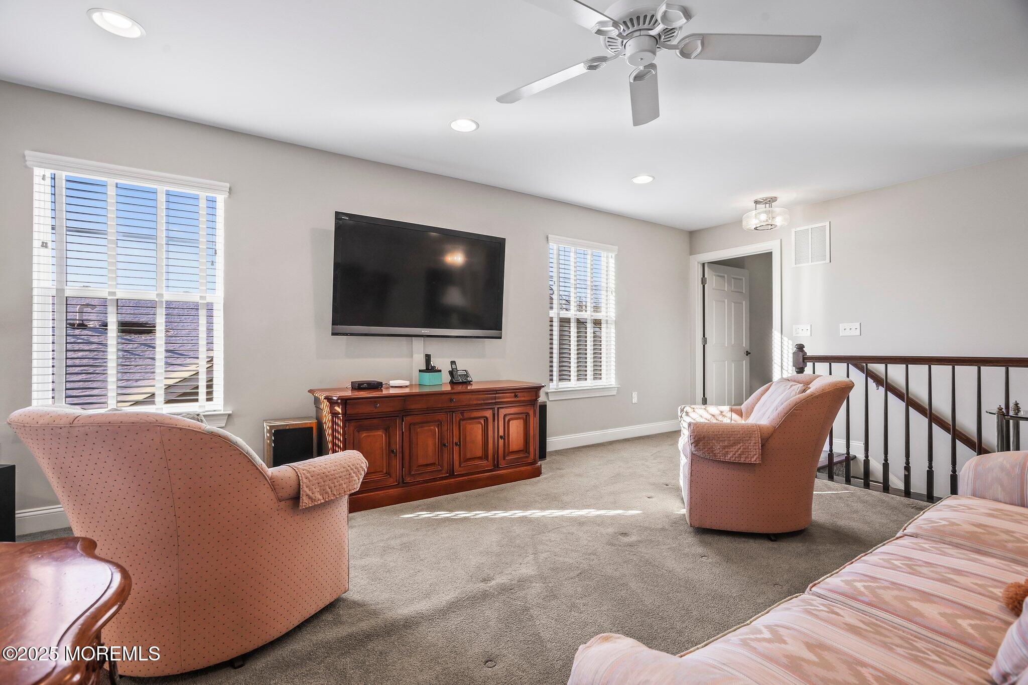 57 Harvest Ridge Road Howell, NJ 07731 - Photo 27 of 39 a living room with furniture and a flat screen tv