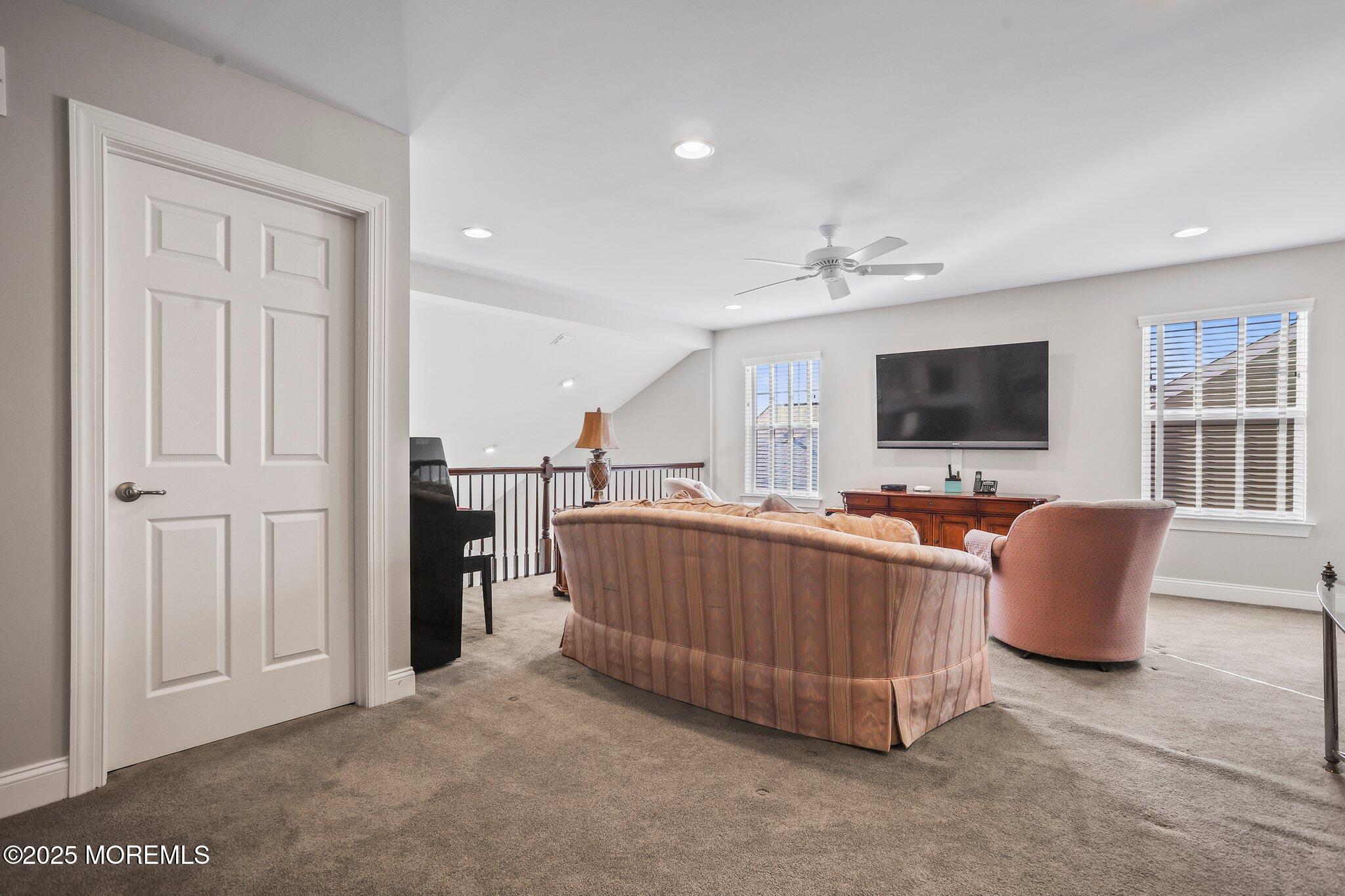 57 Harvest Ridge Road Howell, NJ 07731 - Photo 28 of 39 a living room with furniture and a flat screen tv