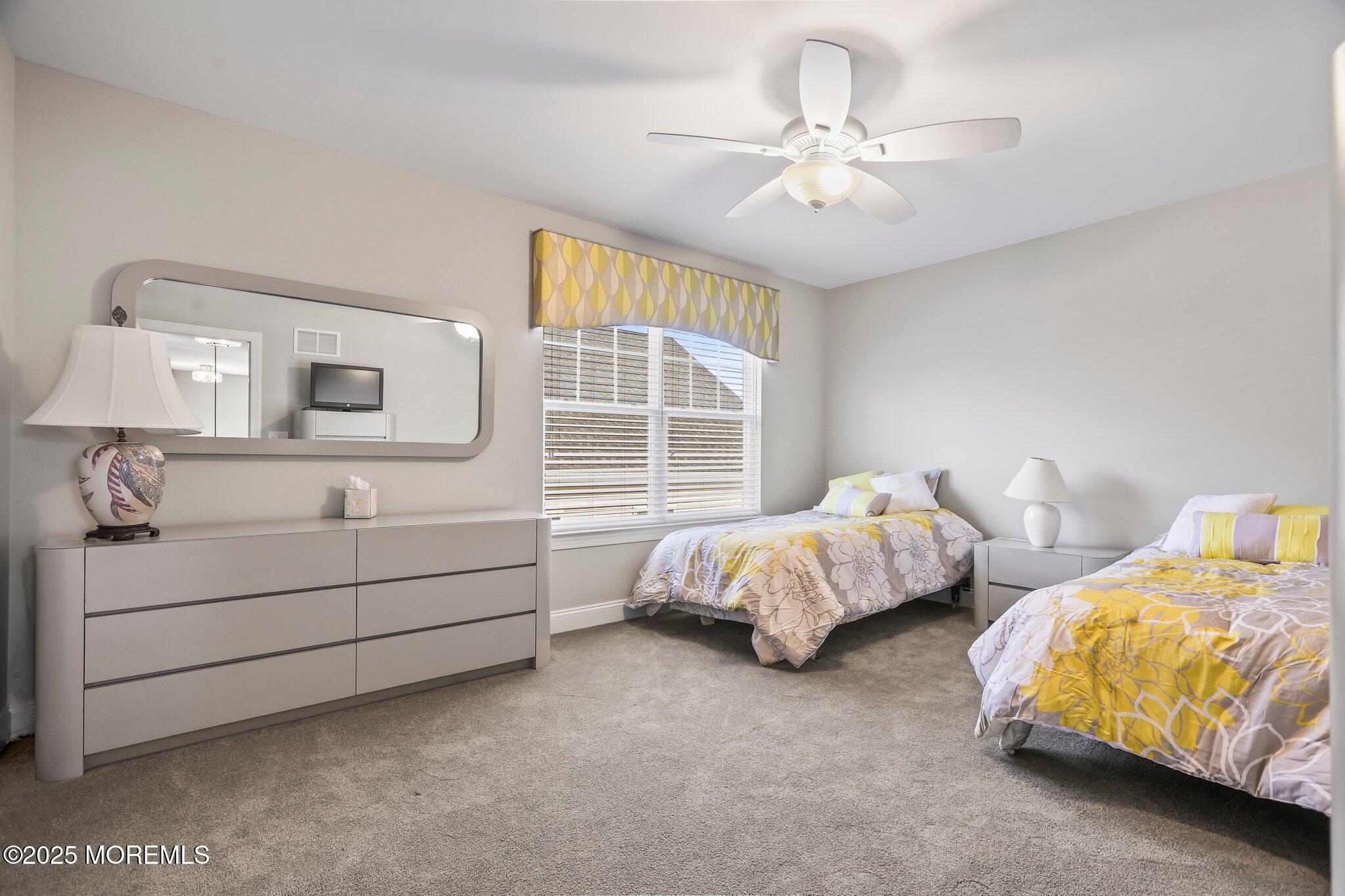 57 Harvest Ridge Road Howell, NJ 07731 - Photo 29 of 39 a spacious bedroom with two bed and window