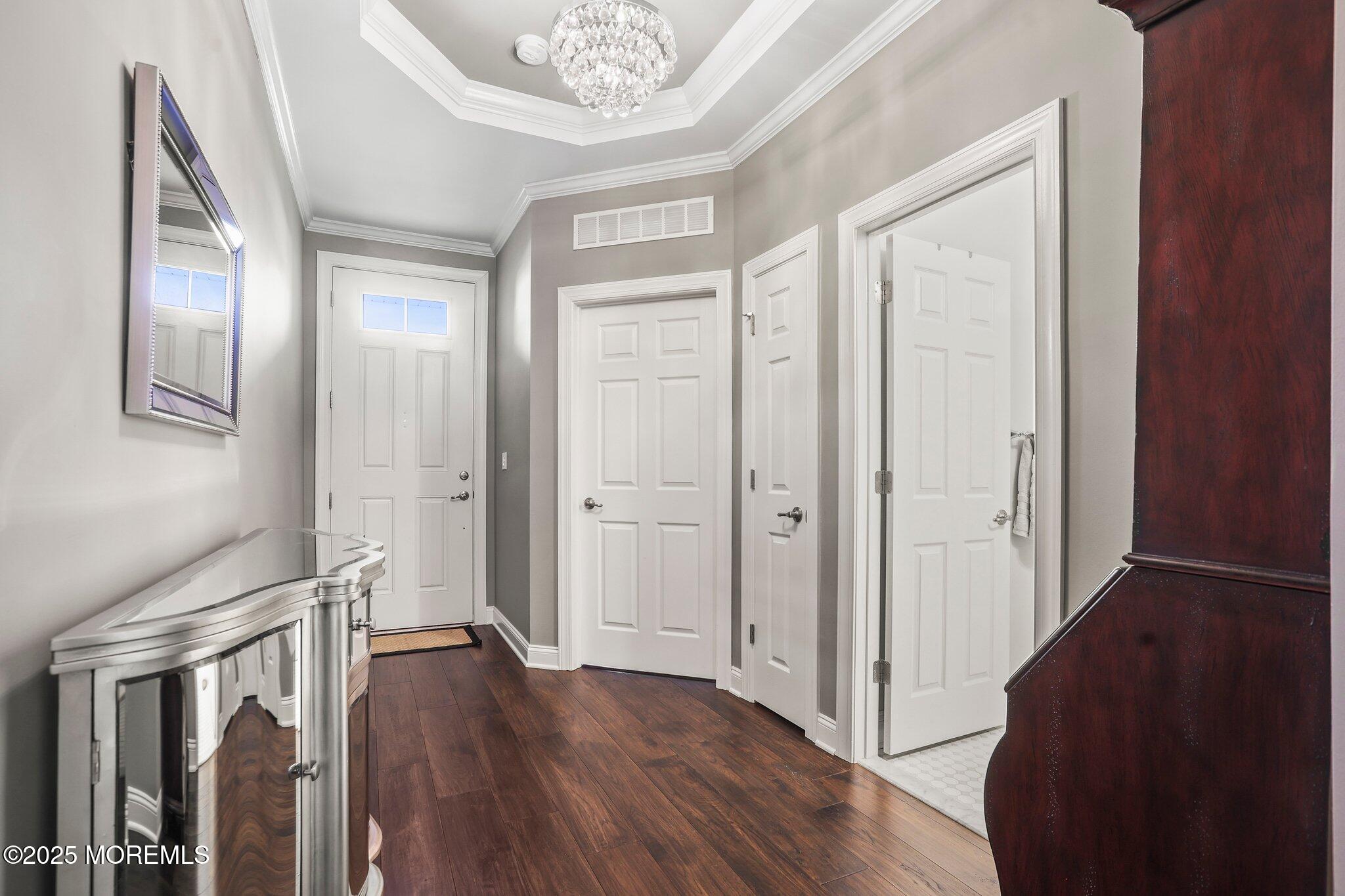 57 Harvest Ridge Road Howell, NJ 07731 - Photo 3 of 39 a view of a hallway with wooden floor and staircase