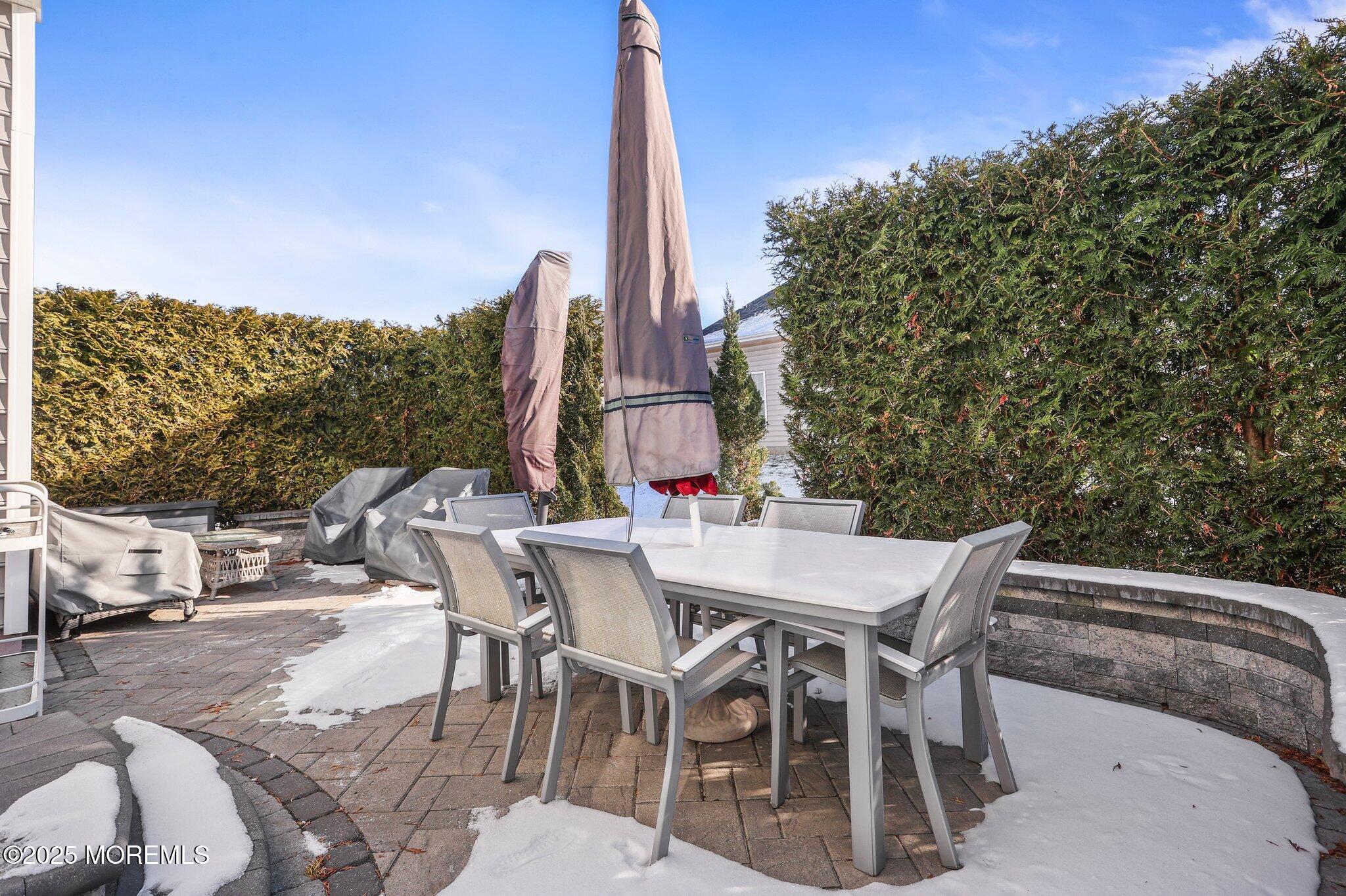 57 Harvest Ridge Road Howell, NJ 07731 - Photo 32 of 39 a view of a patio with table and chairs with wooden floor and fence