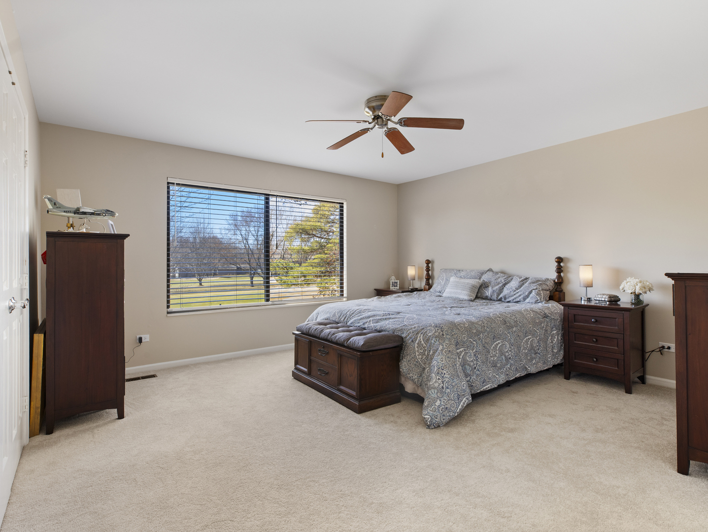 186 Shoreline Road Lake Barrington, IL 60010 - Photo 13 of 25 a spacious bedroom with a large bed and a chandelier
