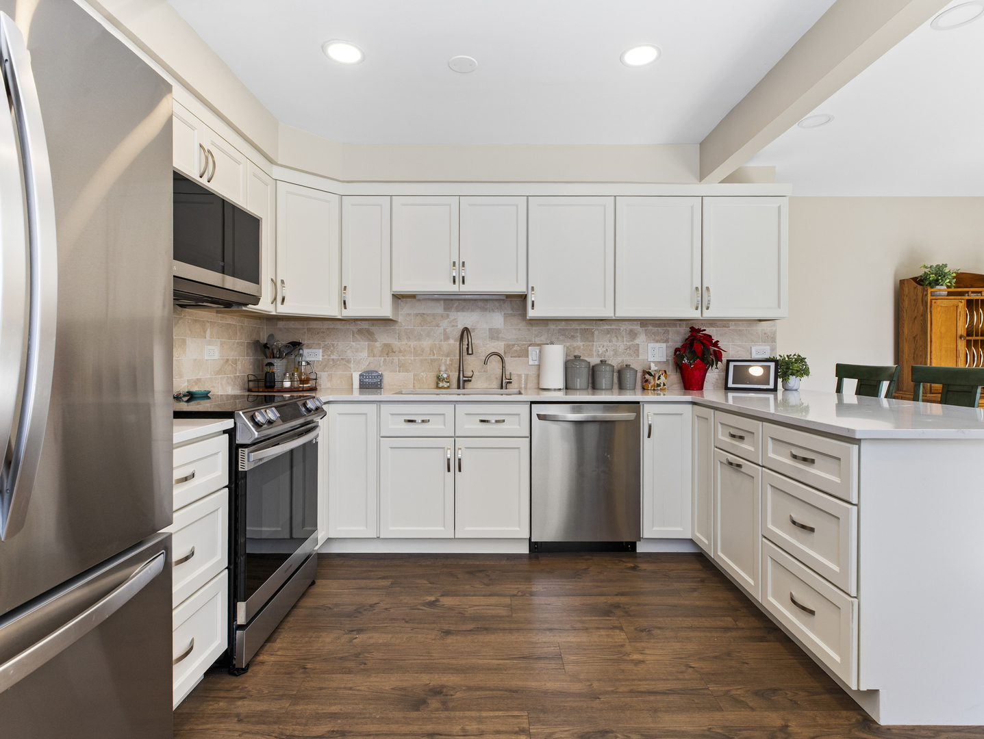 186 Shoreline Road Lake Barrington, IL 60010 - Photo 7 of 25 a kitchen with granite countertop white cabinets and stainless steel appliances