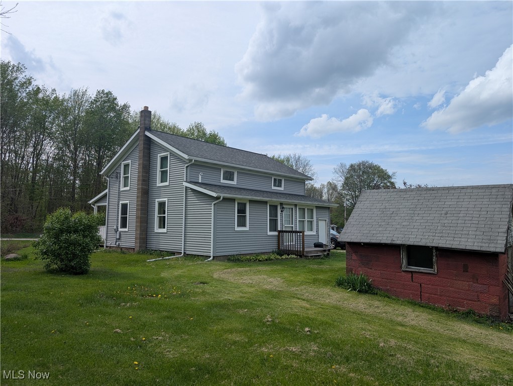 2356 Walter Main Road Geneva, OH 44041 - Photo 5 of 27 Back of house featuring a chimney and a yard