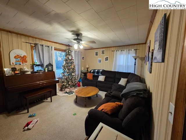 a living room with furniture a desk and chair with wooden floor
