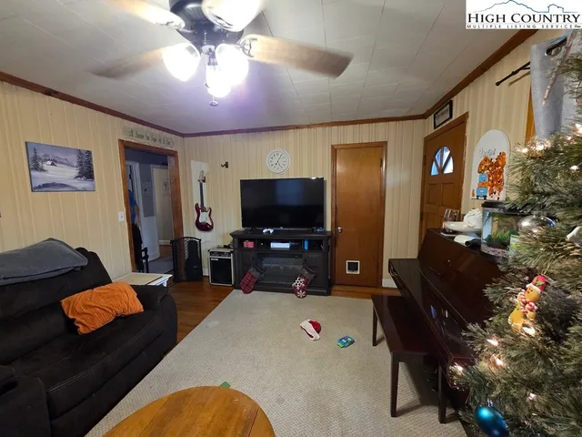 a living room with furniture and a flat screen tv