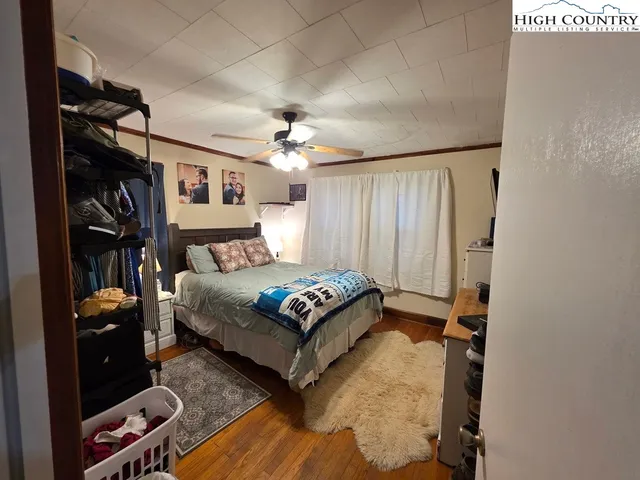 a spacious bedroom with a bed and a chandelier