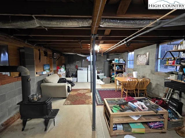 a living room with lots of furniture and clutter