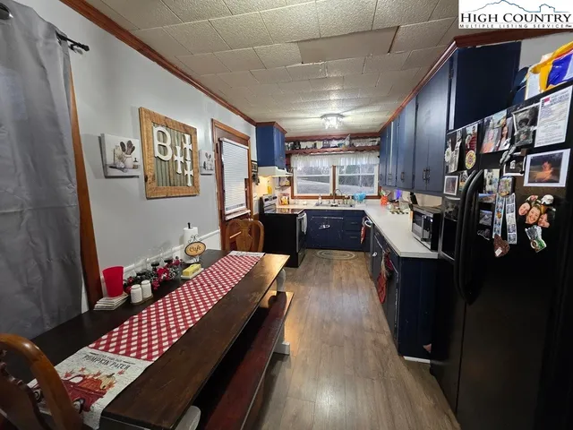 a living room with lots of furniture and kitchen view
