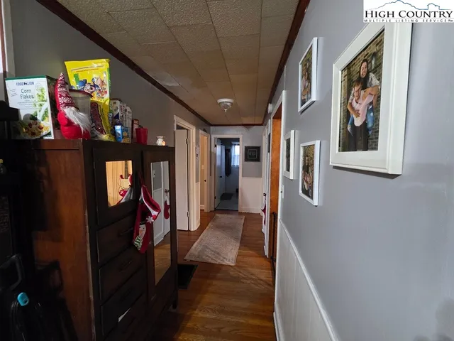 a view of a hallway with paintings on the wall
