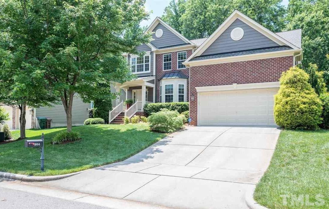 1004 Bianco Drive Raleigh, NC 27607 - Photo 1 of 30 a front view of a house with a yard and garage