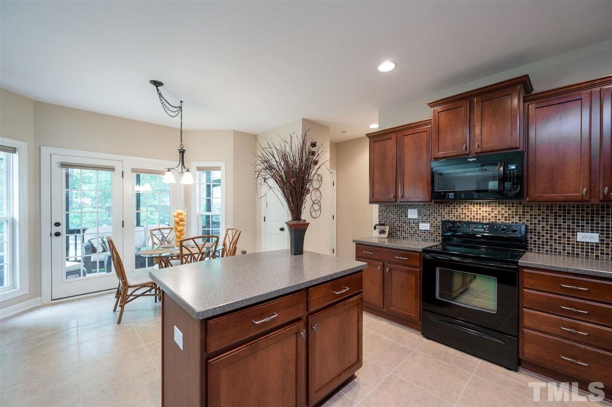 1004 Bianco Drive Raleigh, NC 27607 - Photo 11 of 30 a kitchen with stainless steel appliances granite countertop a sink a stove and a wooden floors