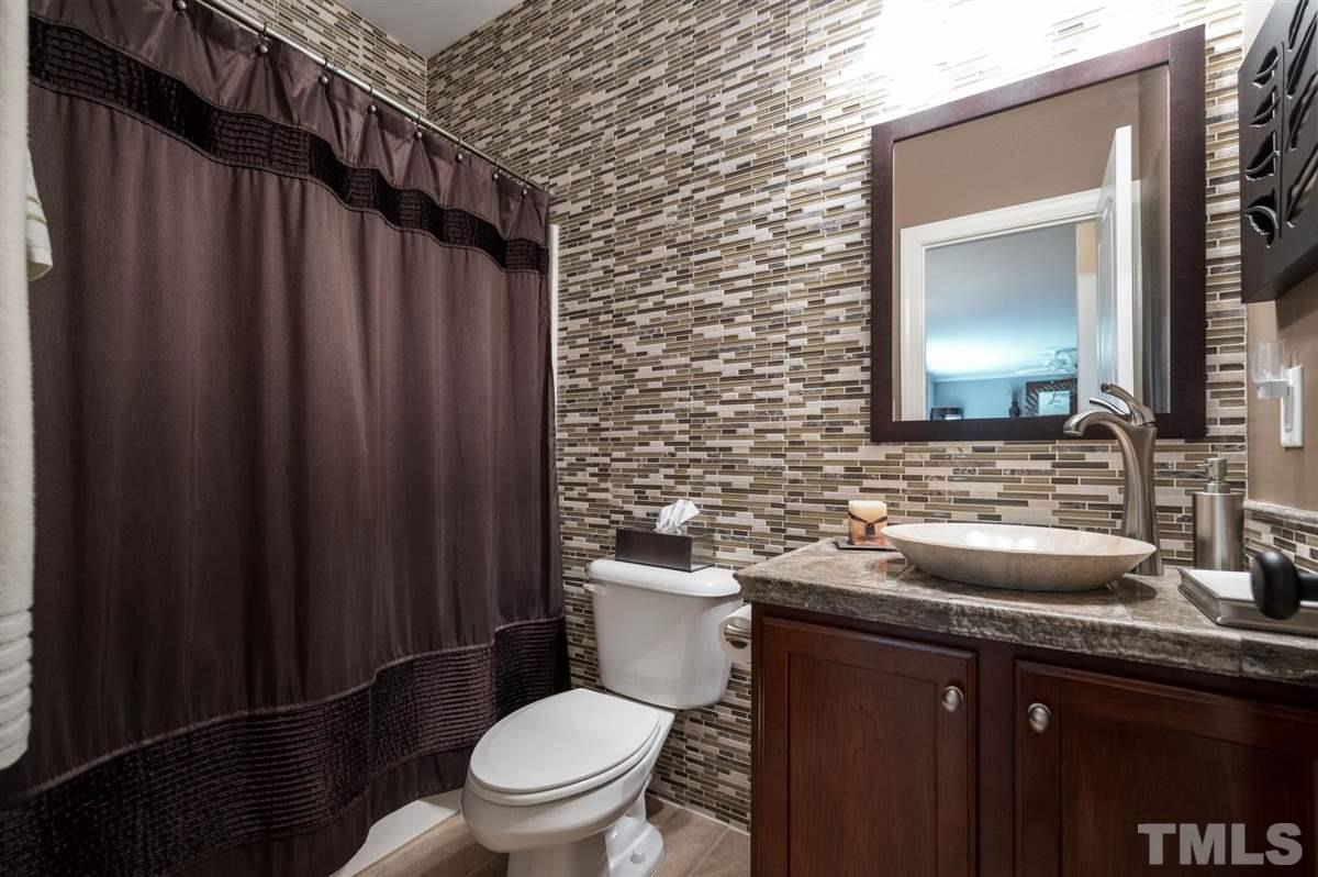 1004 Bianco Drive Raleigh, NC 27607 - Photo 14 of 30 a bathroom with a granite countertop toilet sink and mirror