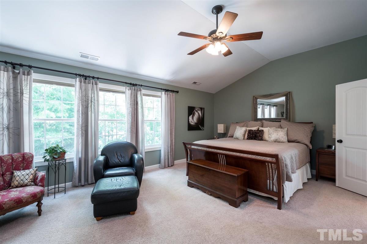 1004 Bianco Drive Raleigh, NC 27607 - Photo 16 of 30 a spacious bedroom with a bed a couch and a window