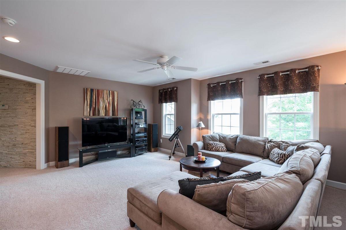 1004 Bianco Drive Raleigh, NC 27607 - Photo 20 of 30 a living room with furniture windows and a flat screen tv