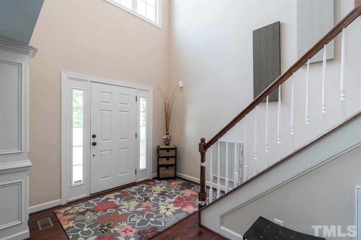 1004 Bianco Drive Raleigh, NC 27607 - Photo 3 of 30 a view of a hallway with wooden floor and stairs