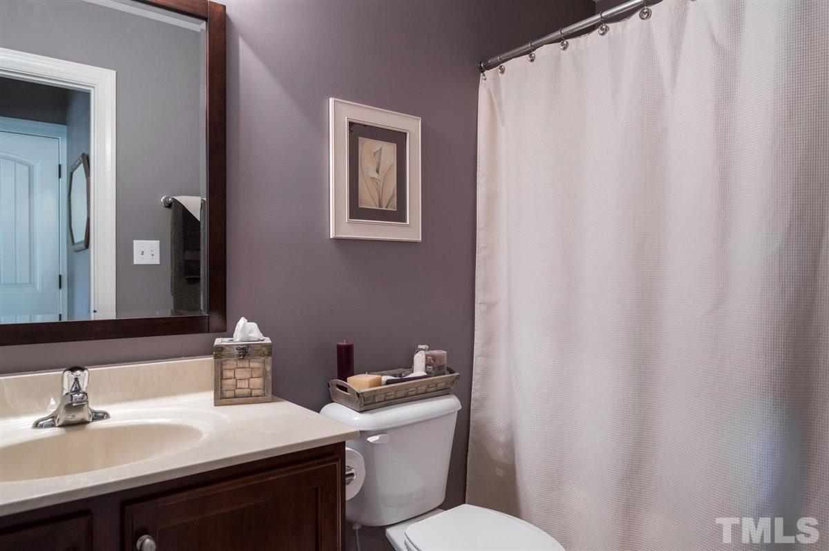 1004 Bianco Drive Raleigh, NC 27607 - Photo 22 of 30 a bathroom with a sink a toilet and a mirror