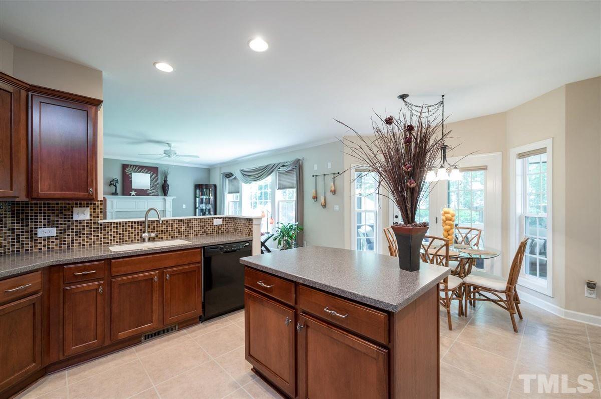 1004 Bianco Drive Raleigh, NC 27607 - Photo 10 of 30 a kitchen with stainless steel appliances granite countertop a sink a stove and a wooden floors